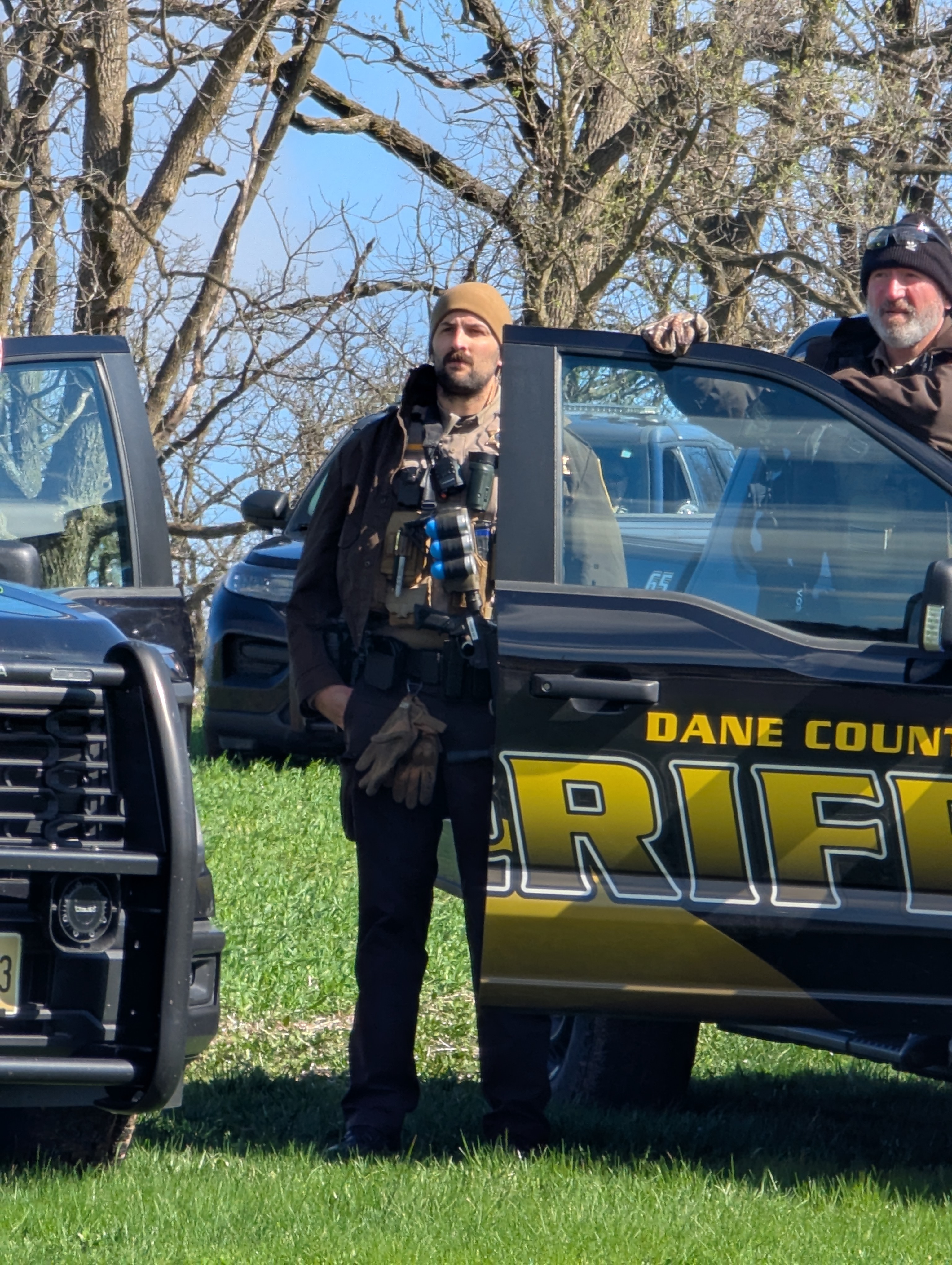 An officer carrying a less-lethal weapon.
