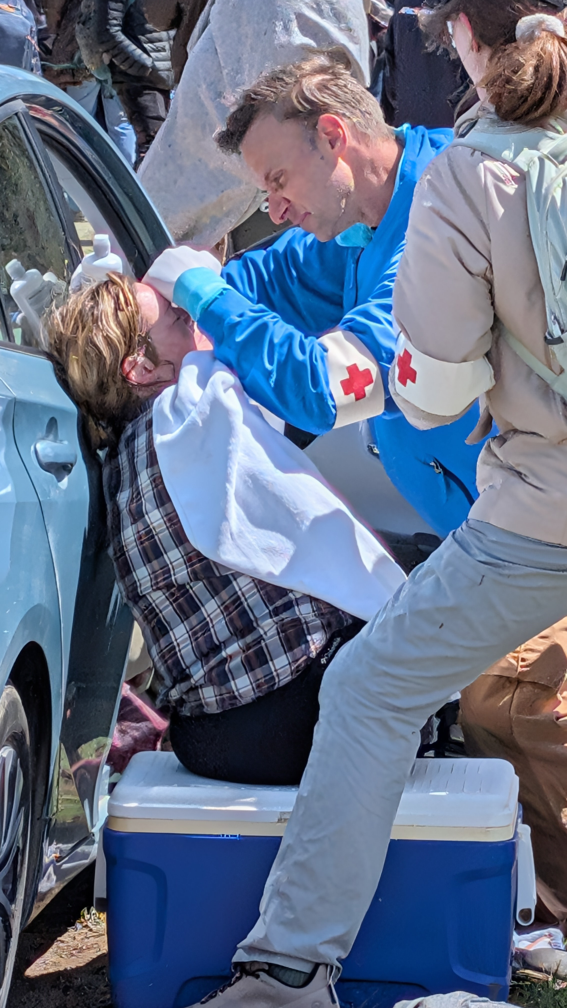 A medic provides aid to an injured rescuer.
