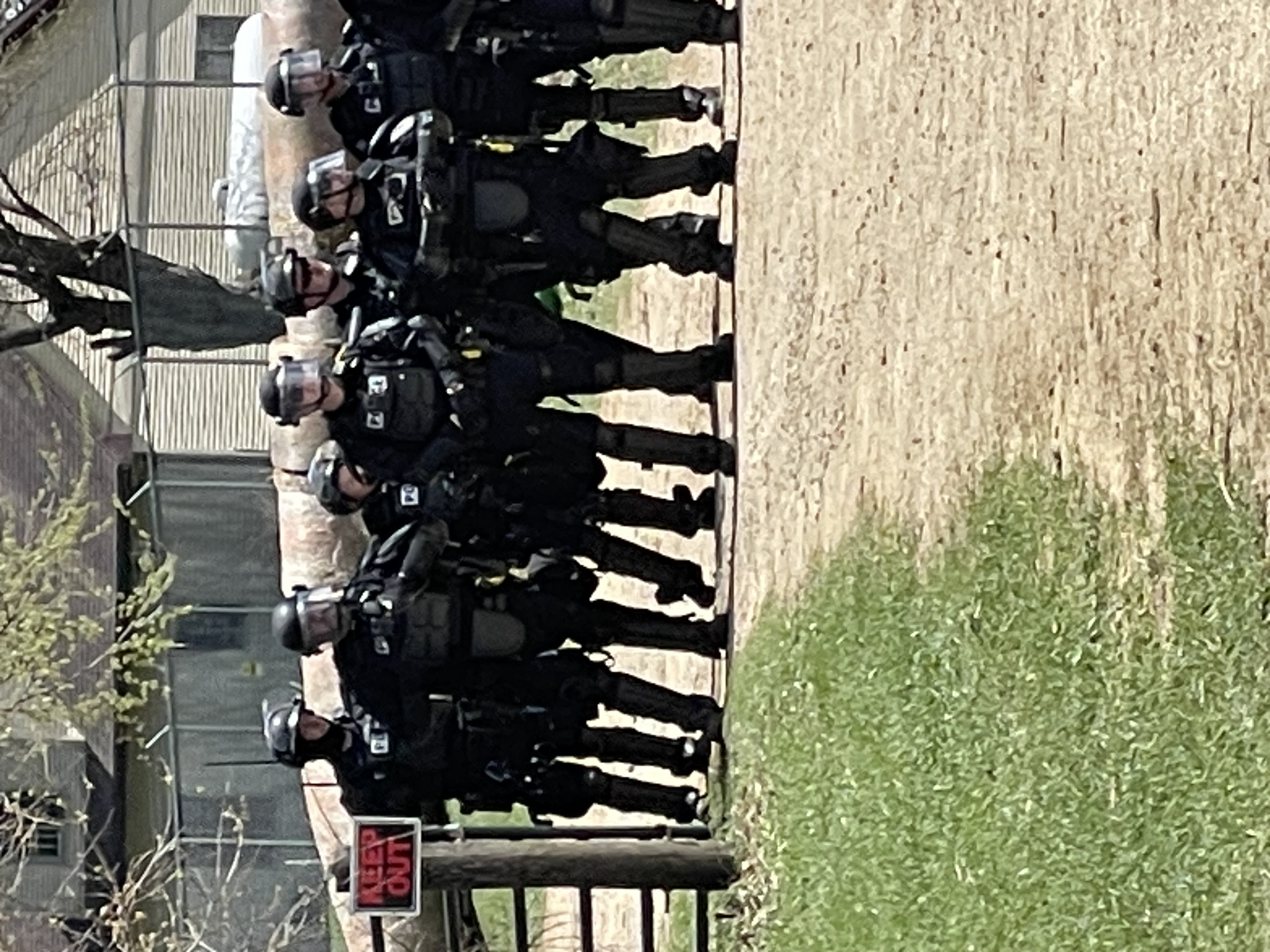 Riot police staged in the driveway.