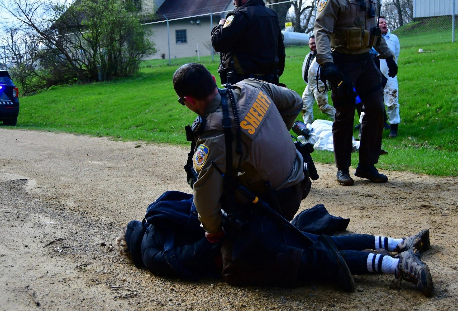 A sheriff on top of an activist.