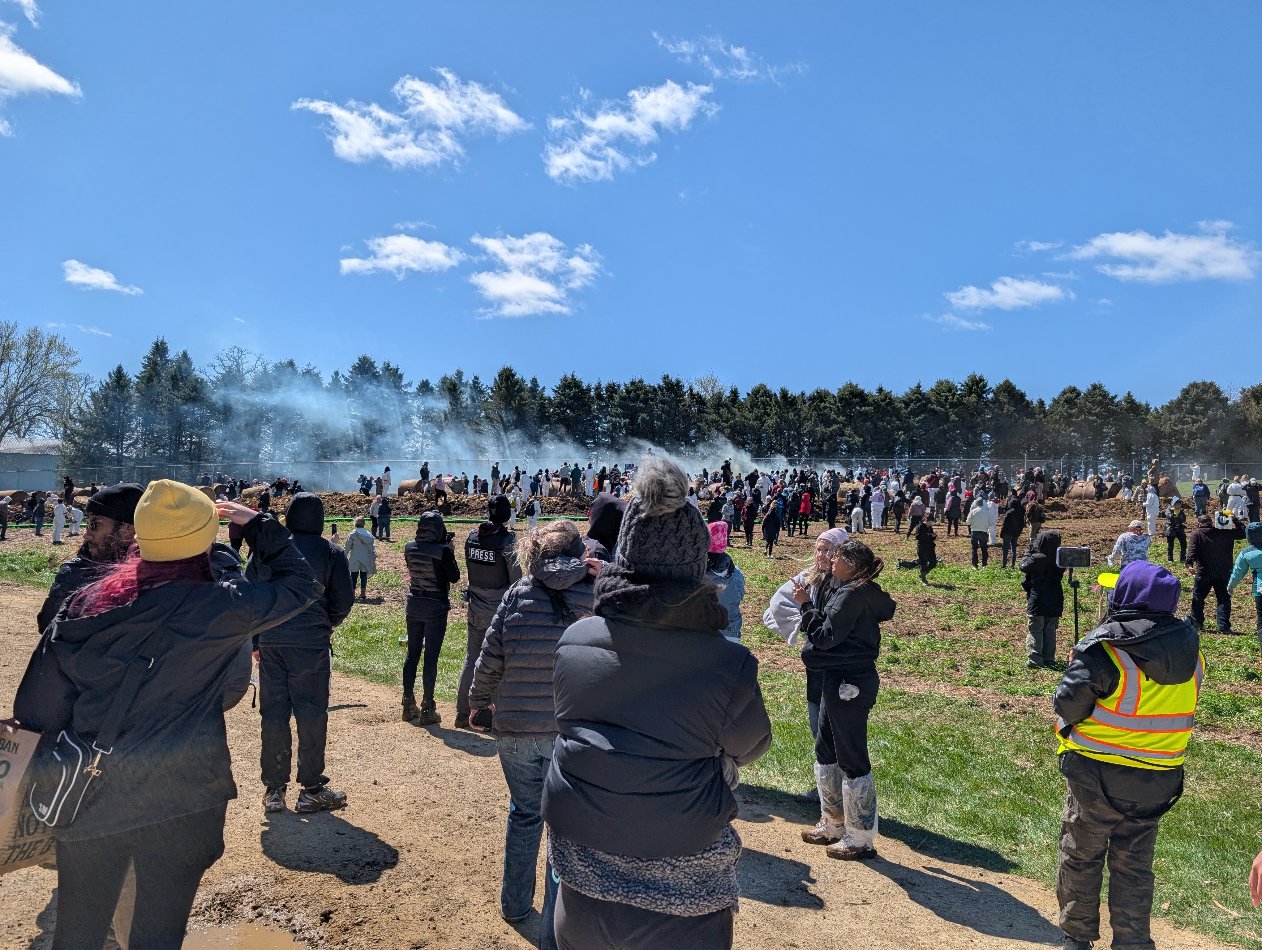 Tear gas drifts across the field.